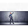 Image of young businessman pulling blank banner from above