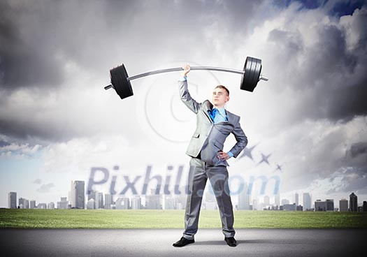Image of strong businessman lifting barbell above head with one hand Image of strong businessman lifting barbell above head with one hand
