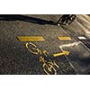 Biker/Cyclist on a crossing in a city casting a long shadow