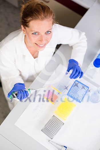 Portrait of a female researcher doing research in a lab (shallow DOF; color toned image)