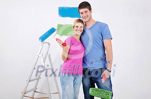 happy young couple paint in green and blue color white wall of their new home happy young couple paint in green and blue color white wall of their new home
