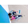 happy young couple relax after painting white wall in green and blue color in their new home