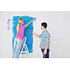 happy young couple paint in green and blue color white wall of their new home