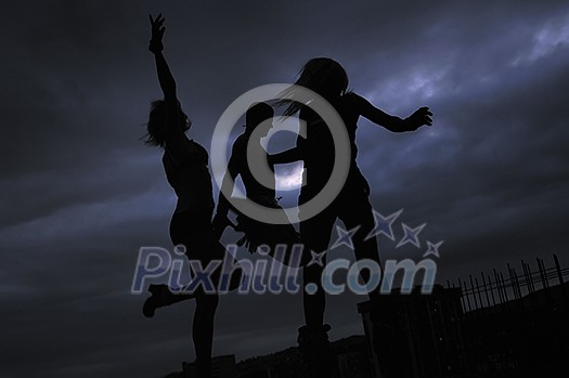 group of people jumping in air in night