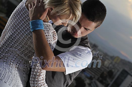 romantic urban couple dancing on top of the bulding romantic urban couple dancing on top of the bulding