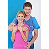 happy young couple paint in green and blue color white wall of their new home