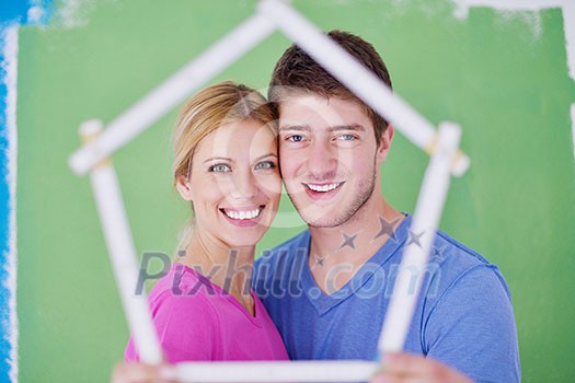 happy young couple paint in green and blue color white wall of their new home happy young couple paint in green and blue color white wall of their new home
