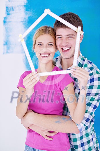 happy young couple paint in green and blue color white wall of their new home happy young couple paint in green and blue color white wall of their new home
