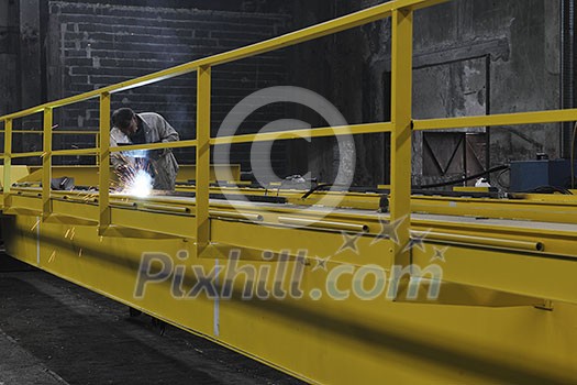 hard iron and steel industri worker working indoor in factory with weld machine