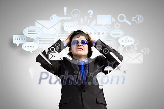 Image of depressed businessman tearing his hair Image of depressed businessman tearing his hair