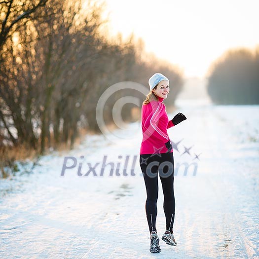 Winter running - Young woman running outdoors on a cold winter day