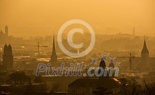 View of Zurich from above - misty winter evening and smoke View of Zurich from above - misty winter evening and smoke