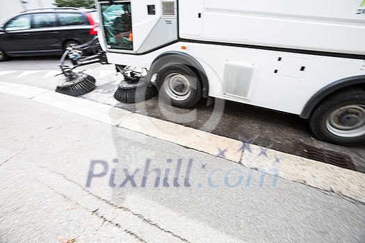 Detail of a street sweeper machine/car cleaning the road Detail of a street sweeper machine/car cleaning the road