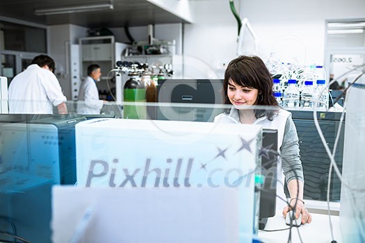 Portrait of a female researcher doing research in a lab (shallow DOF; color toned image)