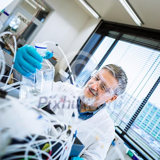 Senior male researcher carrying out scientific research in a lab (shallow DOF; color toned image)