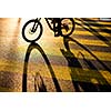 Biker/Cyclist on a crossing in a city casting a long shadow