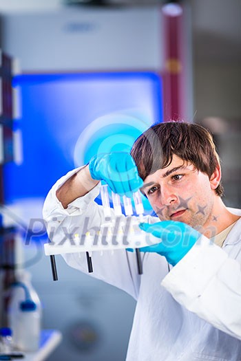 Young male researcher carrying out scientific research in a lab (shallow DOF; color toned image)