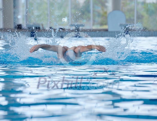 health and fitness lifestyle concept with young athlete swimmer recreating on indoor olimpic pool health and fitness lifestyle concept with young athlete swimmer recreating on indoor olimpic pool
