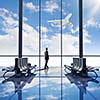 Businessman at airport looking at airplane taking off