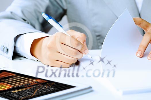 Image of businesswoman sitting at table and drawing sketch