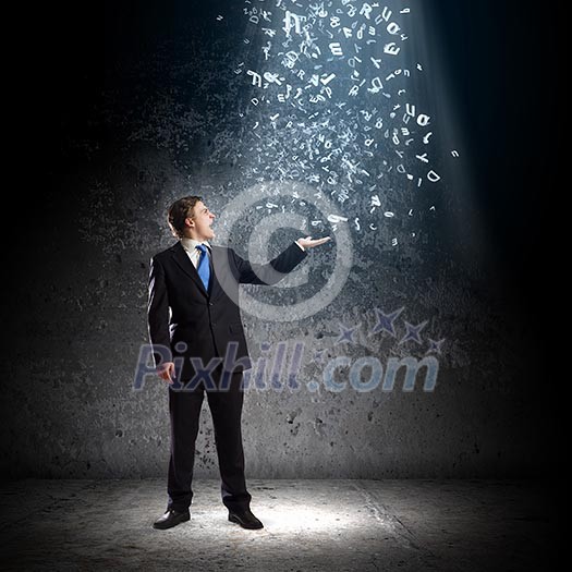 Young woman in suit catching letters falling from above