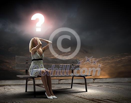 Young woman sitting on bench closing eyes with palms