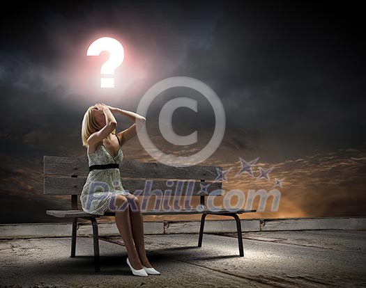 Young woman sitting on bench closing eyes with palms Young woman sitting on bench closing eyes with palms