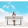 Young pretty asian woman sitting on bench and reading book