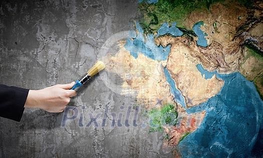 Close up of hand painting Earth planet with brush. Elements of this image are furnished by NASA Close up of hand painting Earth planet with brush. Elements of this image are furnished by NASA