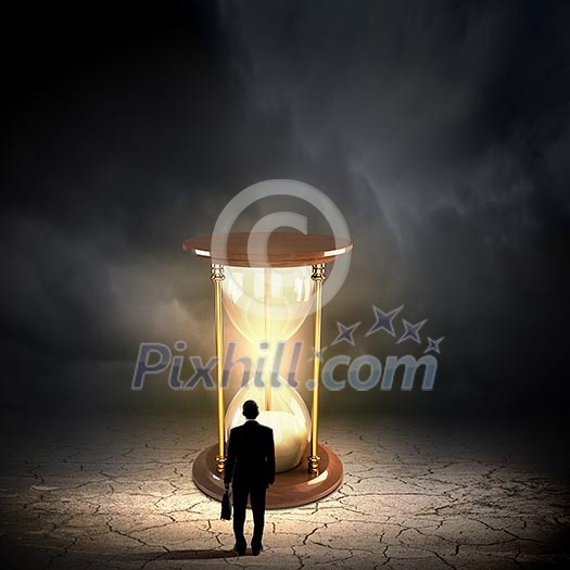 Conceptual image with sandglass and rear view of businessman