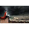Superman in cape and mask sitting on top of building and reading book