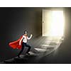 Young confident superman in mask and cape walking on ladder