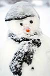 Real snowman with black hat and scarf