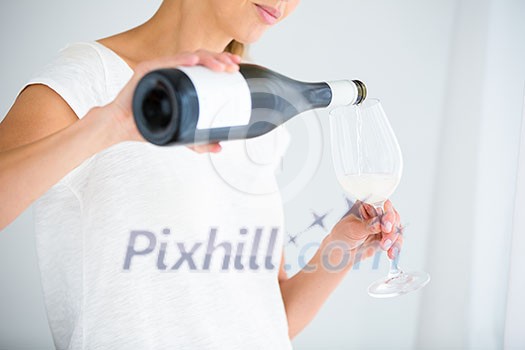 Gorgeous young woman with a glass of wine, smelling the lovely drink, savouring   every sip (shallow DOF; color toned image)