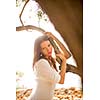 Attractive, young brunette on the beach, amid olive trees, looking both sensual and natural