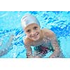 happy little child portrait on swimming school classes and recreation at indoor pool