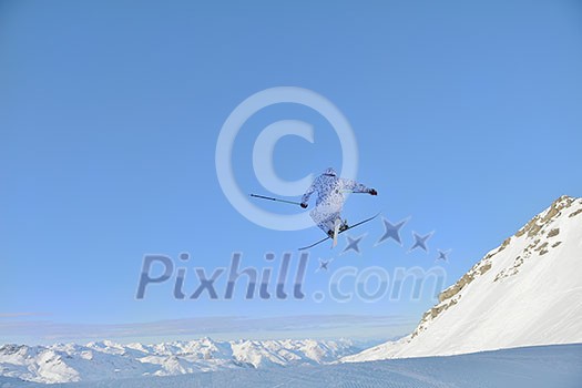 jumping freestyle skier at mountain with fresh snow fresh sunny winter day