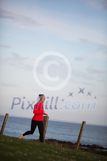 Young woman on her evening jog along the seacoast