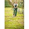 Portrait of a handsome senior man gardening in his garden, on a lovely spring day (color toned image)