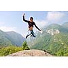 happy young man jump in nature while representing healthy lifestyle freedom and active concept