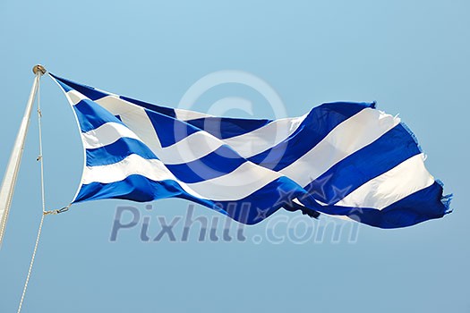 greece flag in wind at day with blue background greece flag in wind at day with blue background