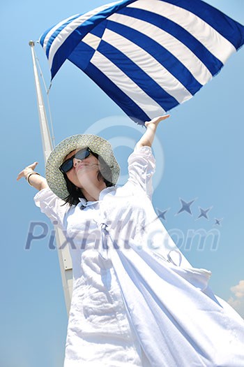 Beautiful young Greek woman in fashion clothes have fun at n the streets of Oia, Santorini, Greece Beautiful young Greek woman in fashion clothes have fun at n the streets of Oia, Santorini, Greece