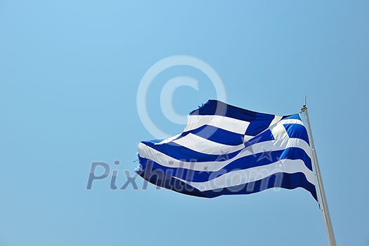 greece flag in wind at day with blue background greece flag in wind at day with blue background