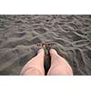 woman feets on beach sand