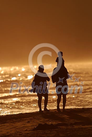 young family walking on beach