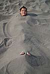 happy children buried in sand