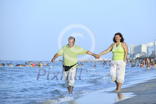 happy senior mature elderly people couple have romantic time on beach at sunset 