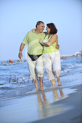happy senior mature elderly people couple have romantic time on beach at sunset happy senior mature elderly people couple have romantic time on beach at sunset