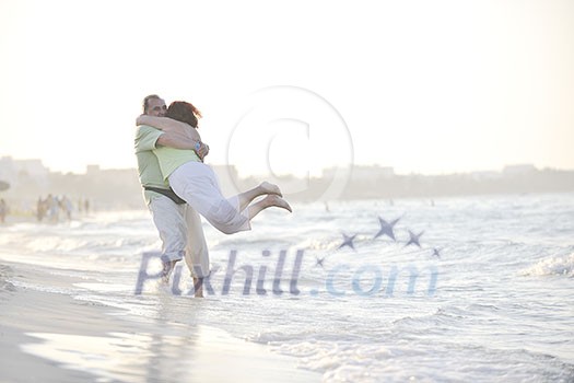 happy senior mature elderly people couple have romantic time on beach at sunset 