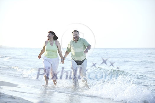 happy senior mature elderly people couple have romantic time on beach at sunset 